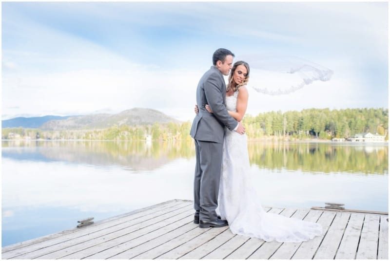 Blog_Carolyn-and-Stevie_Lake-Placid-Wedding-Photo_0042-1-1024×686 couple embracing on dock on Mirror Lake