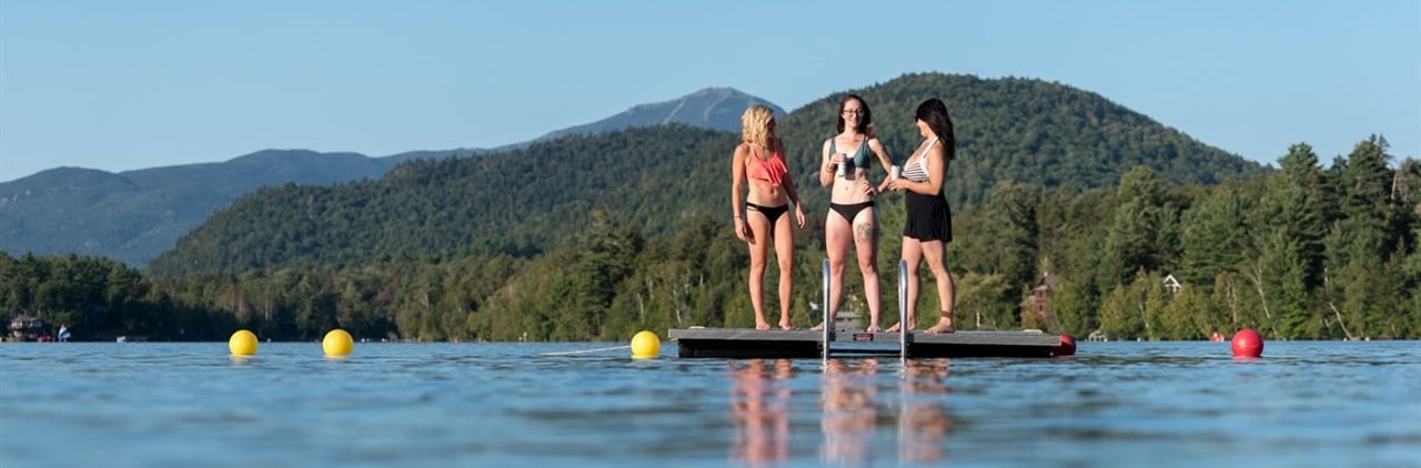 Women standing on floating dock on Mirror Lake.