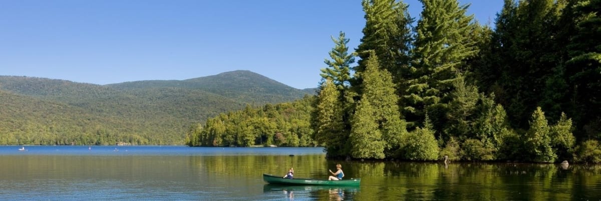 person canoeing around the lake