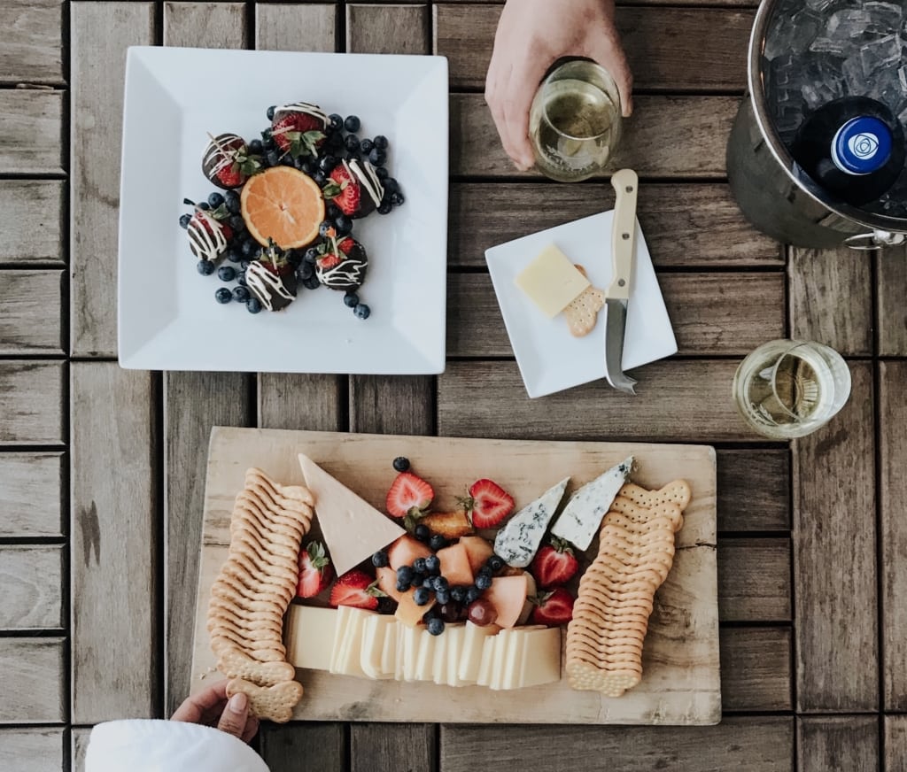 cheese board and chocolate covered strawberries