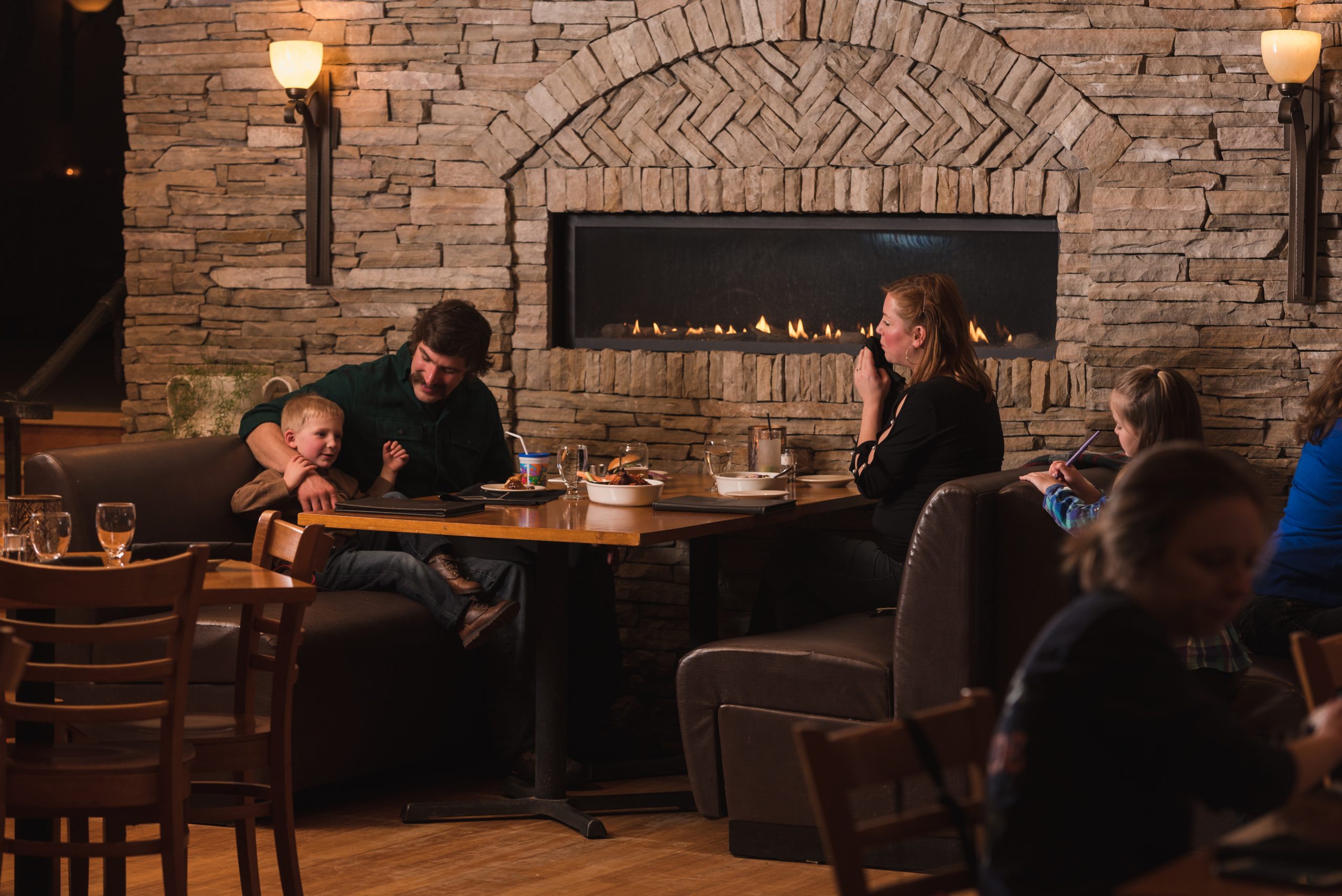 family eating by the indoor fireplace