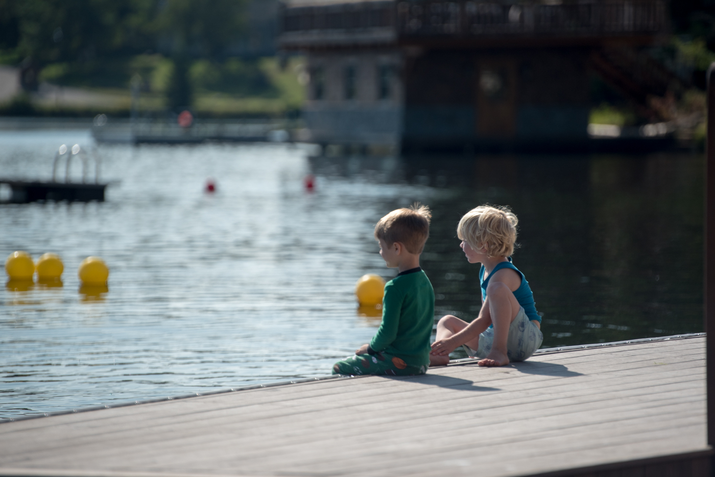 two young boys sitting on dock