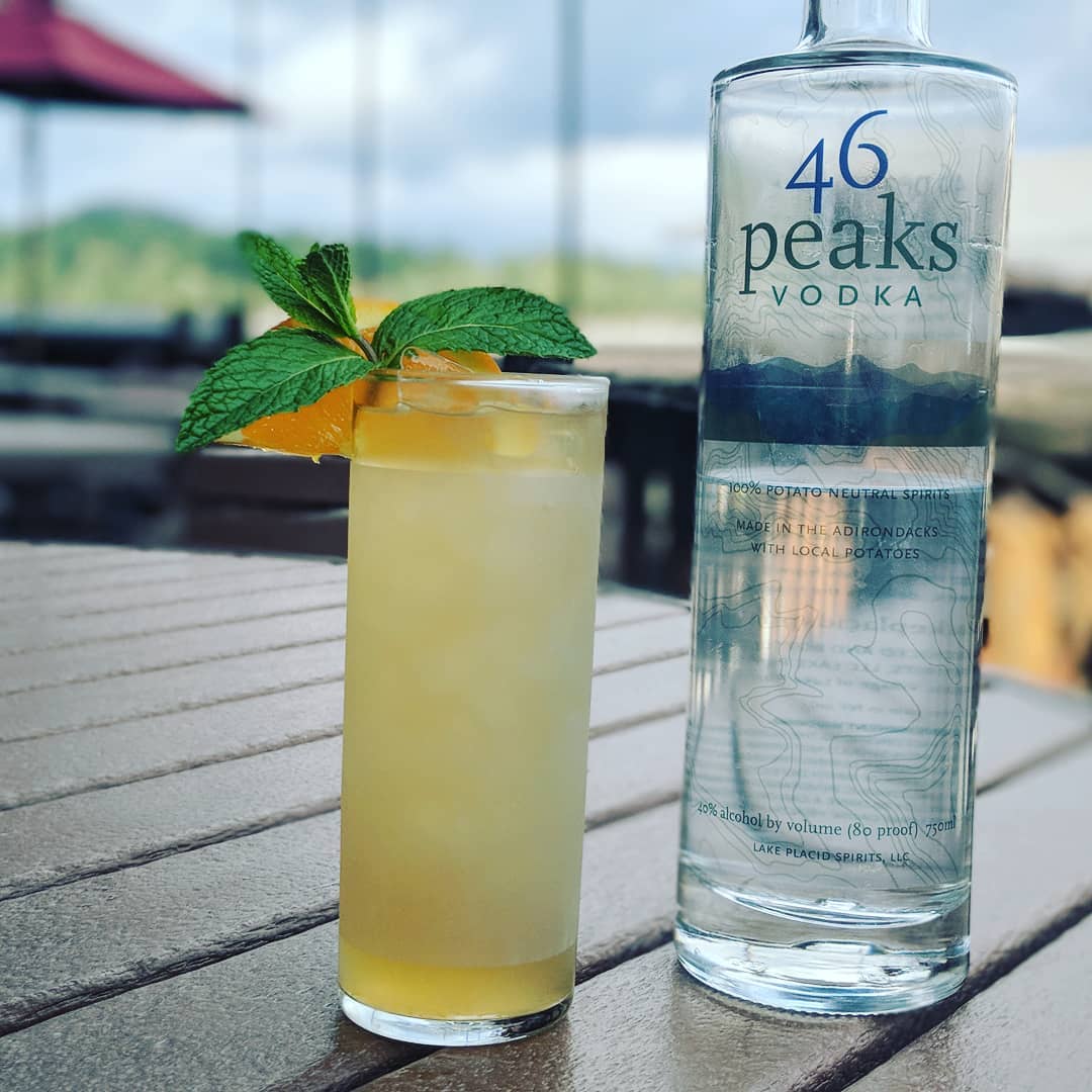 summer cocktail and bottle of 46 Peaks Vodka