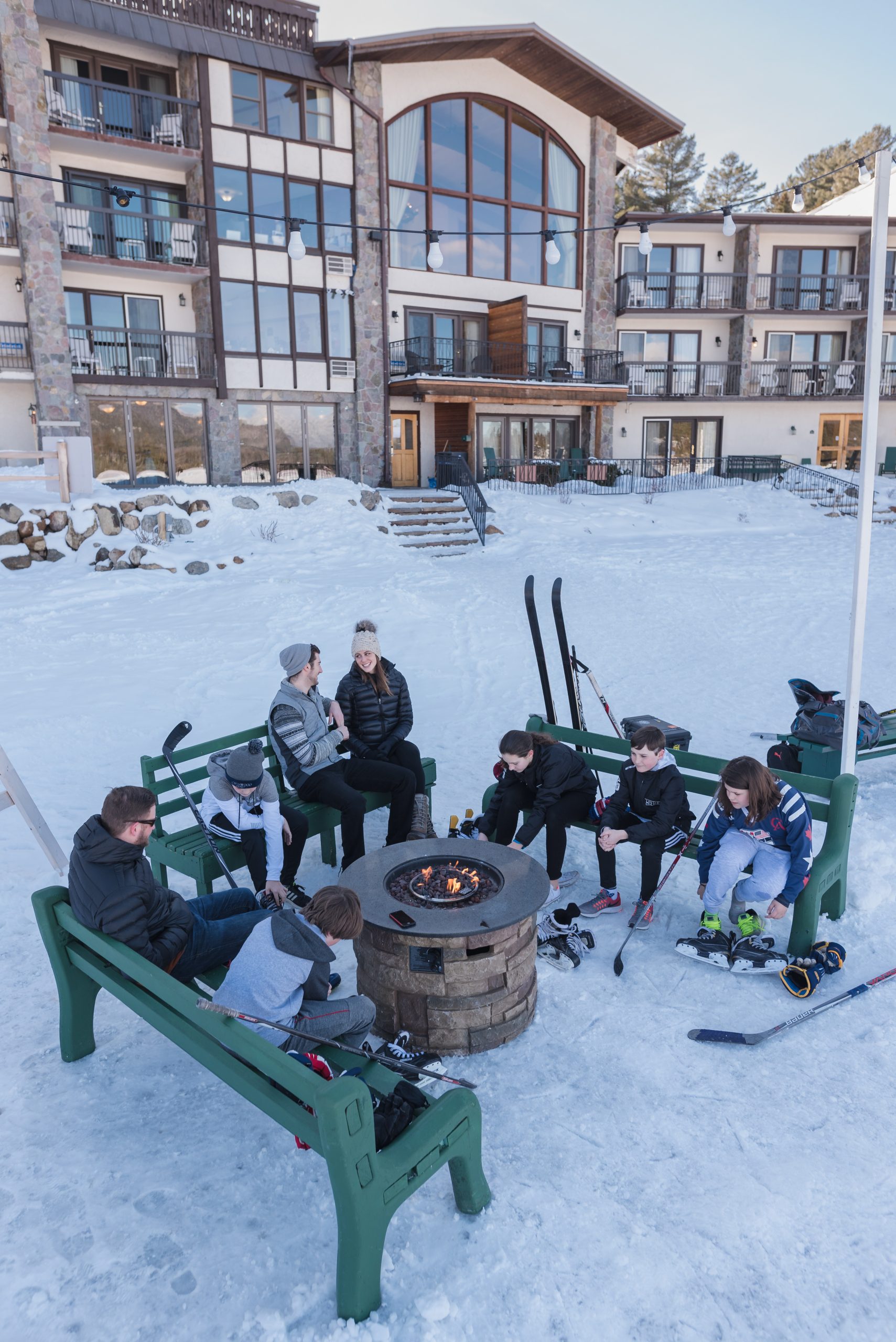 group of people around outdoor firepit in winter