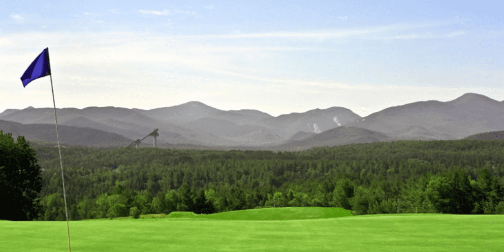 golf course with ski jumps in background