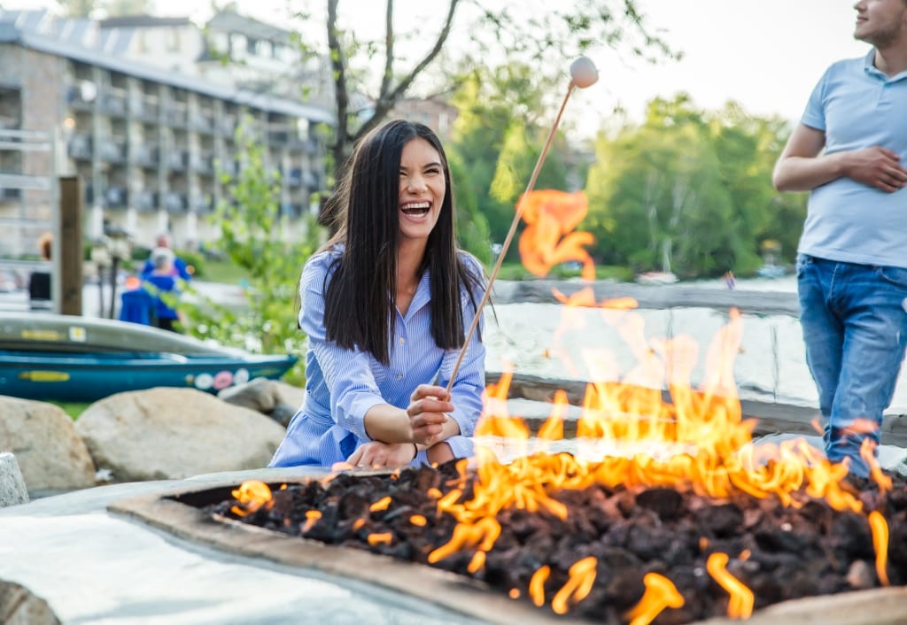 Woman roasting marshmallows at the firepit