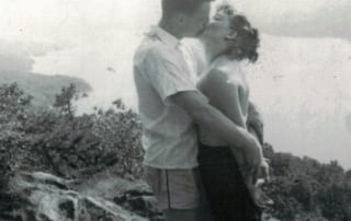 Wini and Stefy Holderied kissing at an overlook of Mirror Lake
