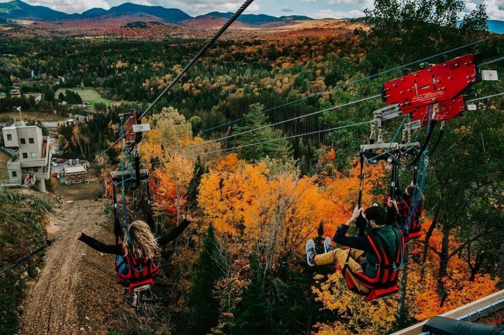 People Ziplining in the fall