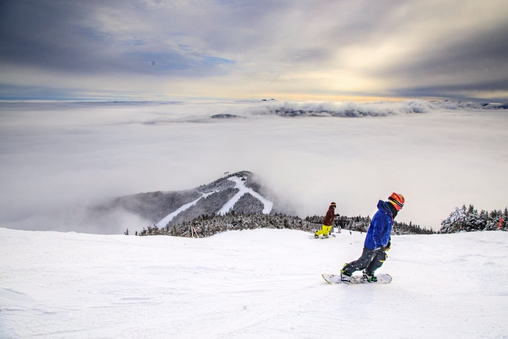 People snowboarding down Whiteface mountain