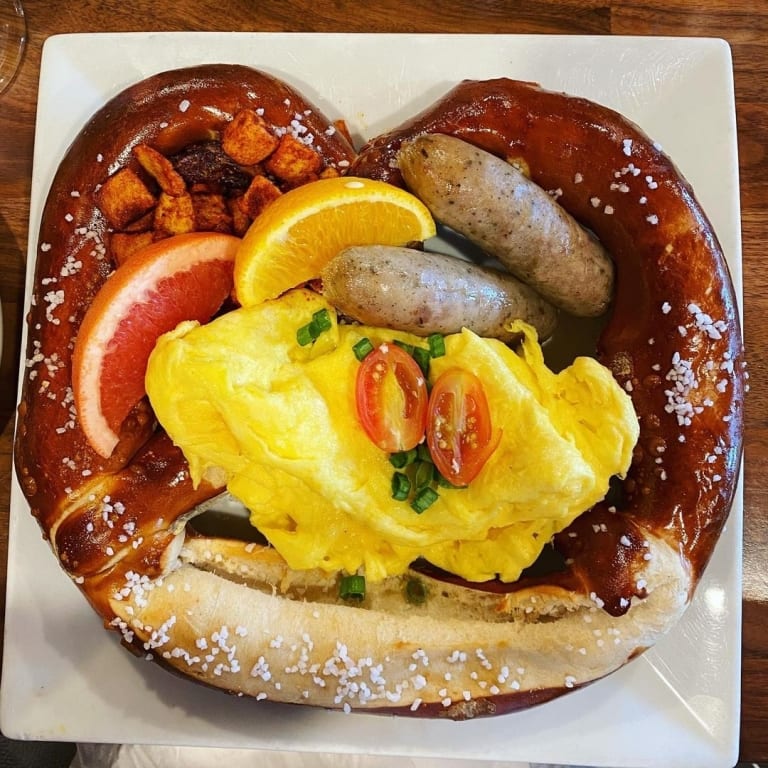 Generations pretzel with scrambled eggs, sausage, and potatoes