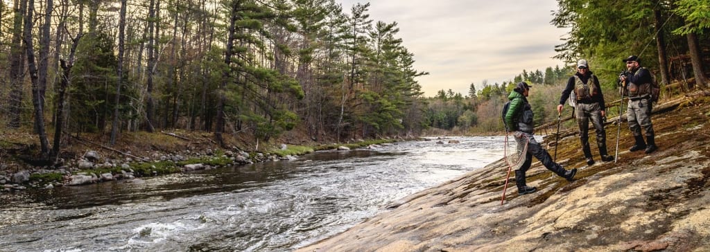 Fly fishermen standing near the river