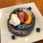 Blueberry pancakes topped with fruit