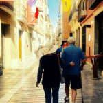 Couple walking down a narrow street in Paris