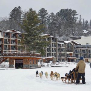Photo of a person dog sledding on Mirror Lake: One of the top Lake Placid winter activities 