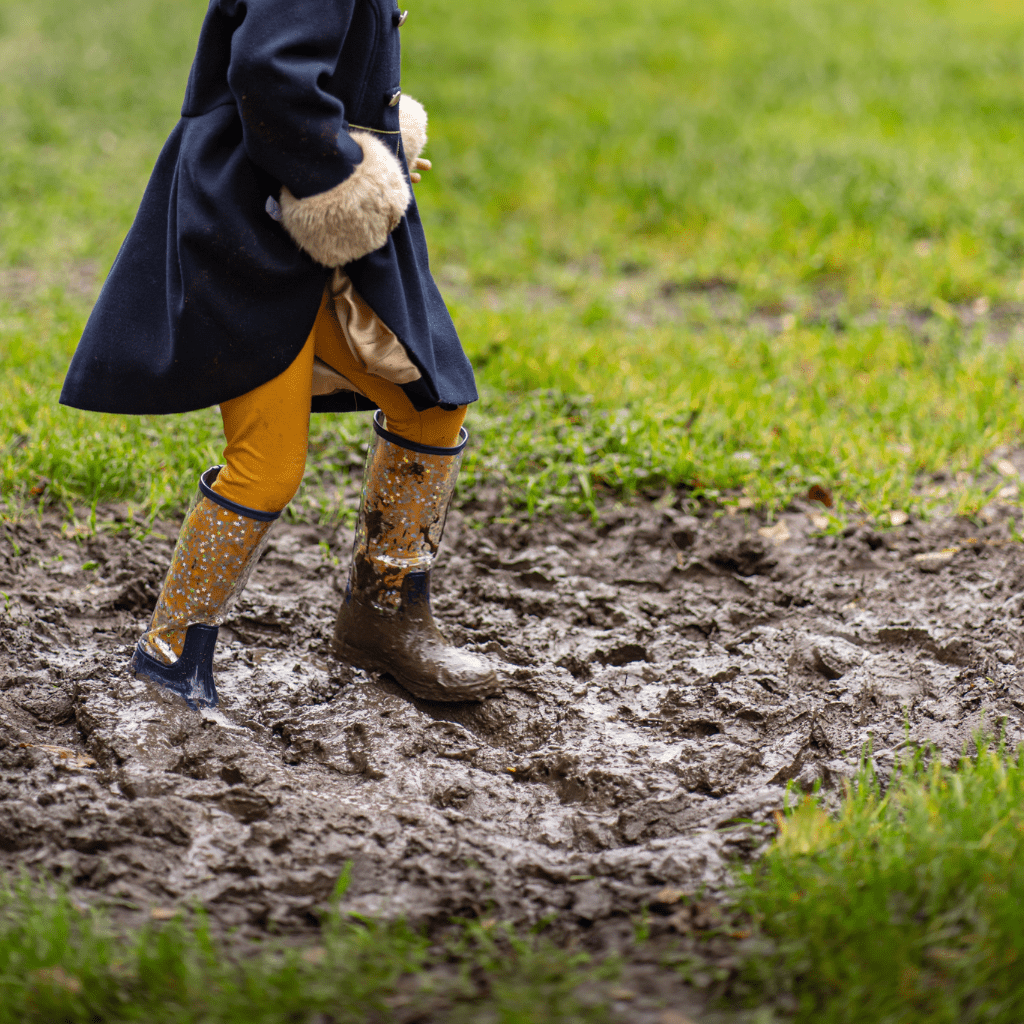 little girl playing in the mud